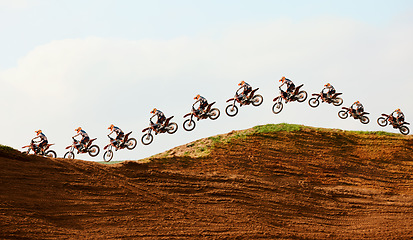 Image showing Motorcycle, sky and double exposure with a sports person on a ramp to jump during a race on an off road course. Bike, training and energy with an athlete on sand or dirt for speed, power or freedom