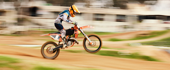 Image showing Motorcycle, balance and motion blur with a man on space at a race course for dirt biking. Bike, fitness and power with a person driving fast on sand or off road for freedom, performance or challenge