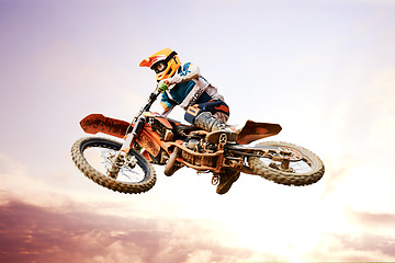 Image showing Sky background, motorcycle and jump for training or sports with fitness, balance or challenge in nature on mock up space. Bike, freedom and adventure for competition and exercise with safety gear