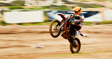 Image showing Bike, balance and motion blur with a man on space at a race for a dirt biking challenge. Motorcycle, speed and power with a person driving fast on an off road course for freedom or performance