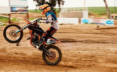 Image showing Motorcycle, power and motion blur with a sports man on space for dirt biking race or challenge. Bike, fitness and speed with a person driving fast on an off road course for freedom or performance