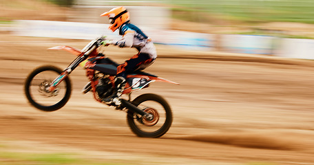 Image showing Motorcycle, balance and motion blur with a man training for a race or dirt biking challenge on space. Bike, fitness and power with a person driving fast on an off road course for freedom or speed