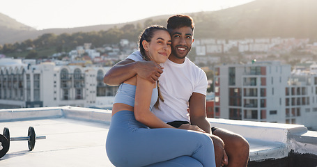 Image showing Fitness, couple for hug during exercise, workout or training together in the urban city. Happy woman, man and care in a conversation, communication or talking after cardio break on a rooftop