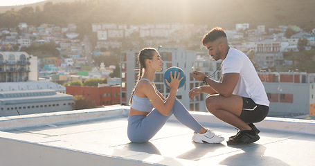 Image showing Exercise, time and a personal trainer with a woman on rooftop outdoor for fitness, workout or training. Couple of friends in city with medicine ball, motivation and support for sit up challenge