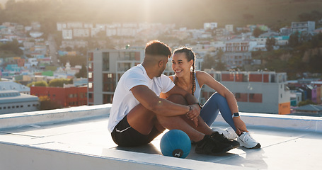 Image showing Fitness, rest and happy couple outdoor for exercise, workout or training together on a city building rooftop. Man and woman on urban break with medicine ball, conversation or health and wellness