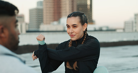 Image showing Fitness, personal trainer and stretching on rooftop in city for exercise, sport or outdoor workout. Woman and man coaching in sports practice, body warmup or cardio together in an urban town