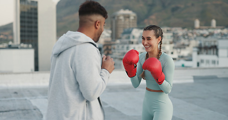 Image showing Coach, boxing and woman outdoor for training on rooftop in a city. Couple of friends, happy athlete and boxer gloves with personal trainer man for martial arts workout, exercise and fight for sports