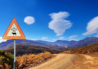 Image showing Desert, sign and alien abduction in the mountains with a ufo warning along a dirt road on a blue sky. Nature, summer and and a route into area 51 with extraterrestrial signage on an empty landscape