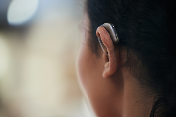 Image showing Hearing aid, closeup and ear with a person with a disability for helping with audio and medical implant. Technology, patient and healthcare problem with listening support and wellness tool with back