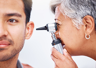 Image showing Hearing test, doctor and patient with healthcare consultation closeup, face and ENT specialist with otoscope. Medical professional, assessment and trust with man and senior woman with ear check