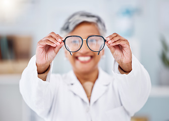 Image showing Medical optician, woman and glasses for vision, eyesight and assessment of prescription lens. Hands of happy optometrist giving frame for eyewear, test and optical consulting eye care exam in clinic