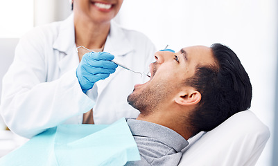 Image showing Man, dentist and check teeth with tools for dental cosmetics, healthcare assessment or medical consulting. Patient, tooth or open mouth in oral cleaning with mirror, excavator or orthodontics surgery