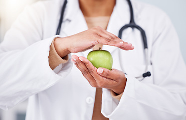 Image showing Hands, apple and doctor, health and diet with nutritionist person, healthy food closeup and lose weight. Dietician, healthcare and wellness, green fruit and clean eating with vegan, organic and fiber