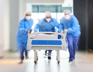 Image showing Running, bed and surgeon team, healthcare expert or group speed for surgery support, emergency services or medical help. Wellness, fast motion blur and doctors rush patient for first aid teamwork