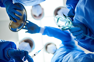 Image showing Surgery team, below and a doctors in a hospital or theatre to start operation with anesthesia. Surgeon, assistant and medical group together for emergency healthcare with a oxygen mask and syringe