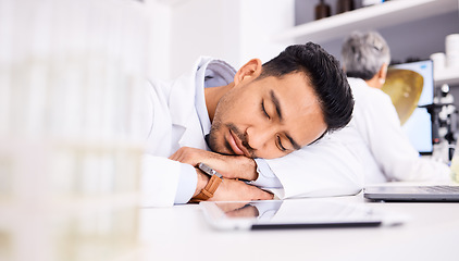 Image showing Asian man, scientist and sleeping on desk in laboratory, burnout or overworked in mental health. Tired male person, medical or healthcare worker asleep in lab rest, dreaming or fatigue at workplace