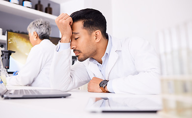 Image showing Scientist, tired and headache of computer research, planning and data analysis, mistake or healthcare results. Stress or sad science man or doctor working on laptop in medical or chemistry laboratory