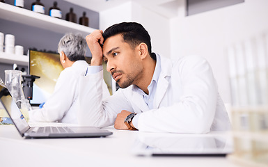 Image showing Scientist, stress and headache for computer research, planning and data analysis, mistake or healthcare results. Sad or tired science man or doctor working on laptop in medical or medicine laboratory