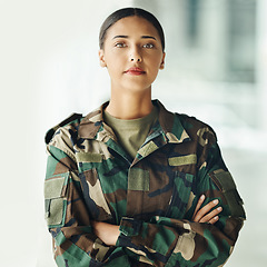 Image showing Confident soldier portrait, woman and arms crossed in army building, pride and professional hero service. Military career, security and courage, proud girl in camouflage uniform at government agency.