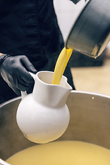 Image showing Chicken broth pours into the serving jug