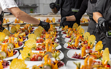 Image showing Cooks are garnishing appetizer plates