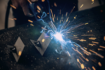 Image showing Worker welding the iron