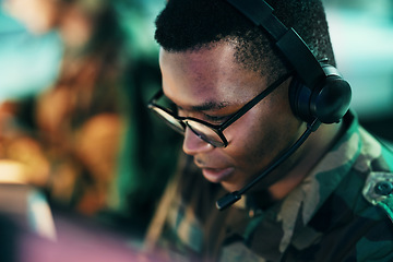 Image showing Military control room, surveillance and man monitor, reading or check CCTV, army communication or security. Headset, emergency consultation and face of African soldier consulting on intel support