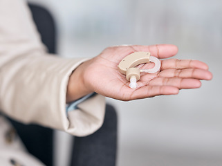 Image showing Hearing aid, medical and deaf with hands of person with a disability for healthcare, technology and sound waves. Medicine, wellness and audio with closeup of cochlear implant for hearing treatment