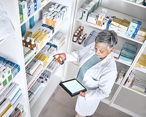 Image showing Medicine, tablet screen and pharmacy woman reading product, bottle or medical stock. Mockup space, top view and mature pharmacist check clinic database for supplements, healthcare or antibiotic info