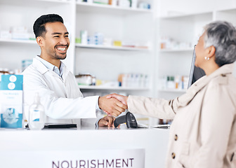 Image showing Pharmacist, doctor and people handshake for pharmacy, medical support and customer service at desk. Professional healthcare worker and woman shaking hands, thank you and success in medicine or retail