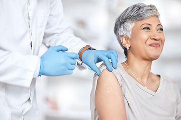 Image showing Healthcare, vaccine and doctor with mature woman in consultation at hospital or clinic. Injection, syringe and happy patient with medical professional for vaccination for covid, insurance and care.