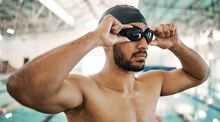 Image showing Getting ready, man and goggles for swimming training, competition or a race in the pool. Fitness, gym and an athlete or swimmer with glasses to start exercise, workout or cardio in a triathlon