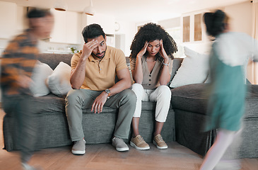 Image showing Frustrated parents, headache and children with stress in burnout, anxiety or depression in living room chaos at home. Couple, family and busy ADHD kids or siblings running around sofa in crazy house