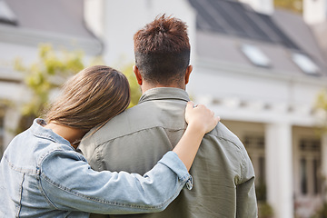 Image showing Couple hug outside new home from back, property or future investment opportunity for young people. Mortgage, real estate and marriage, man and woman in backyard of house with love, embrace and moving