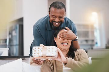 Image showing Birthday gift surprise, cover eyes and couple smile, woman and black man giving package for love, anniversary or gratitude. Living room couch, marriage and home people happy for present box