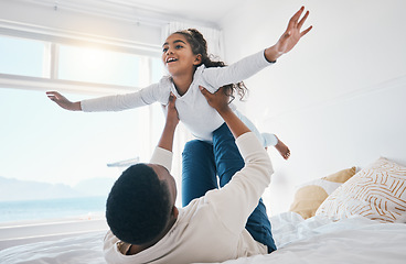 Image showing Airplane, love and father with girl child on a bed for bond, trust or support in their home together. Flying, family time and parent with kid in a bedroom for games, play or fun with weekend freedom