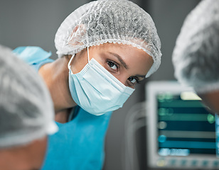 Image showing Portrait, healthcare and a woman surgeon in an operation at the hospital for emergency care closeup. Medical, face and mask for safety with a confident young doctor in a medicine clinic for surgery