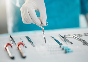 Image showing Surgery equipment, table and hands with scissors for a medical procedure in theater. Closeup, hospital and a doctor or surgeon with gear for healthcare, operation or an emergency service in nursing