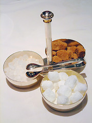 Image showing Bowls with cane sugar, white sugar and candy sugar 