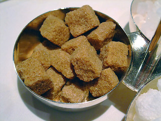 Image showing Bowl of brown and cane sugar cubes