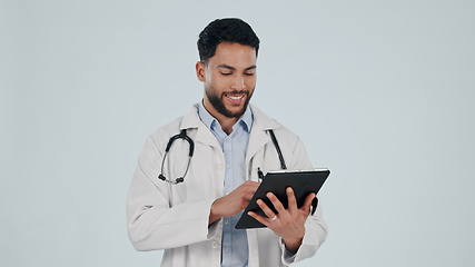Image showing Doctor, man and tablet for healthcare service, social media and clinic software, internet scroll or research in studio. Happy medical worker on digital technology or hospital app on white background
