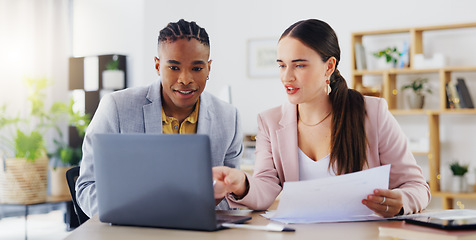 Image showing Laptop, documents and business people in discussion on a project together in the modern office. Teamwork, technology and professional corporate team working on report with paperwork in collaboration.