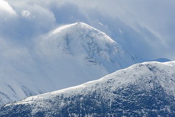 Image showing snowy mountain peak between clouds