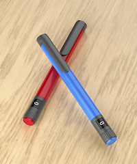 Image showing Blue and red insulin pens