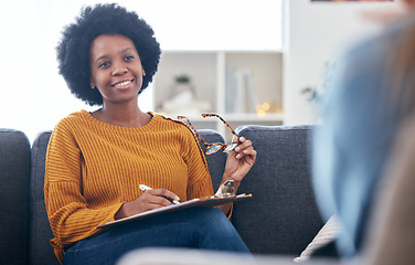 Image showing Psychologist on couch, writing notes with patient, advice and help in psychology, listening and mental health care. Conversation, support and black woman on sofa with client, therapist in counseling.