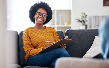 Image showing Black woman therapist on sofa with notes, smile and patient for advice and psychology, listening and mental health care help. Conversation, support and psychologist on couch with client in counseling