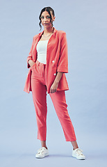 Image showing Fashion, portrait and young businesswoman in studio with makeup, confidence and body in suit. Beauty, style and influencer girl in designer clothes, trendy promo and model standing on blue background