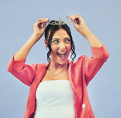 Image showing Fashion, beauty and woman with crown in studio for glamour, luxury and winning prize. Excited, wow and isolated person with tiara for princess pride, confidence and cosmetics on purple background