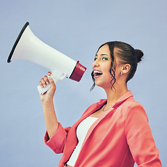 Image showing Megaphone, speech and face of happy woman in studio with announcement, deal or promo on blue background. Microphone, noise and female speaker with bullhorn for attention, information or voice vote