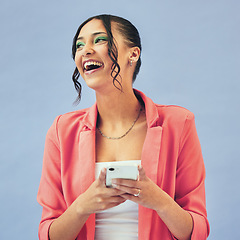 Image showing Happy, face and woman with phone in studio laughing at social media, joke or meme on blue background. Smartphone, app and female model with gif communication, joke or funny chat, text or blog comic